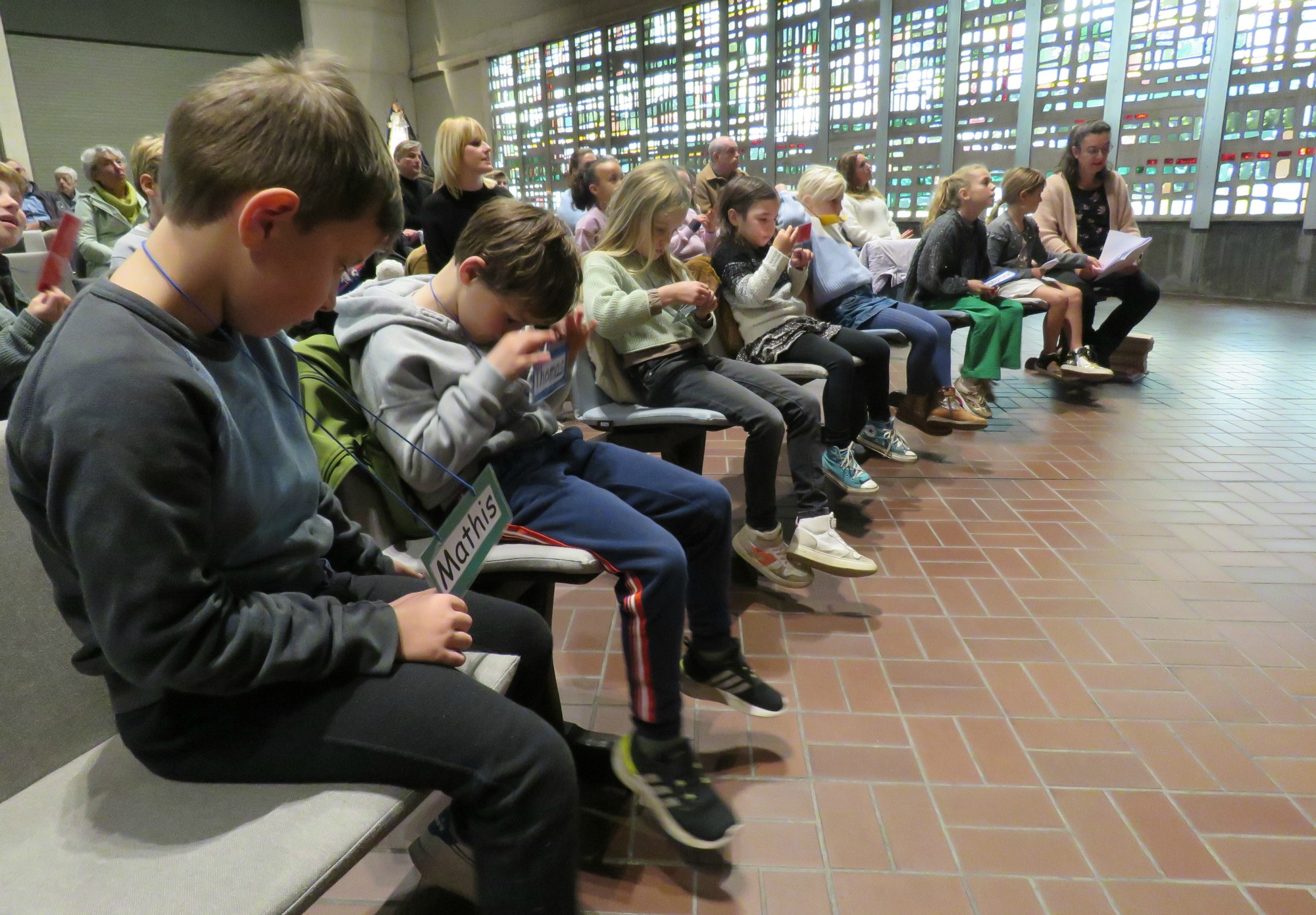 De eerste communicanten en vormelingen zitten vooraan in de kerk