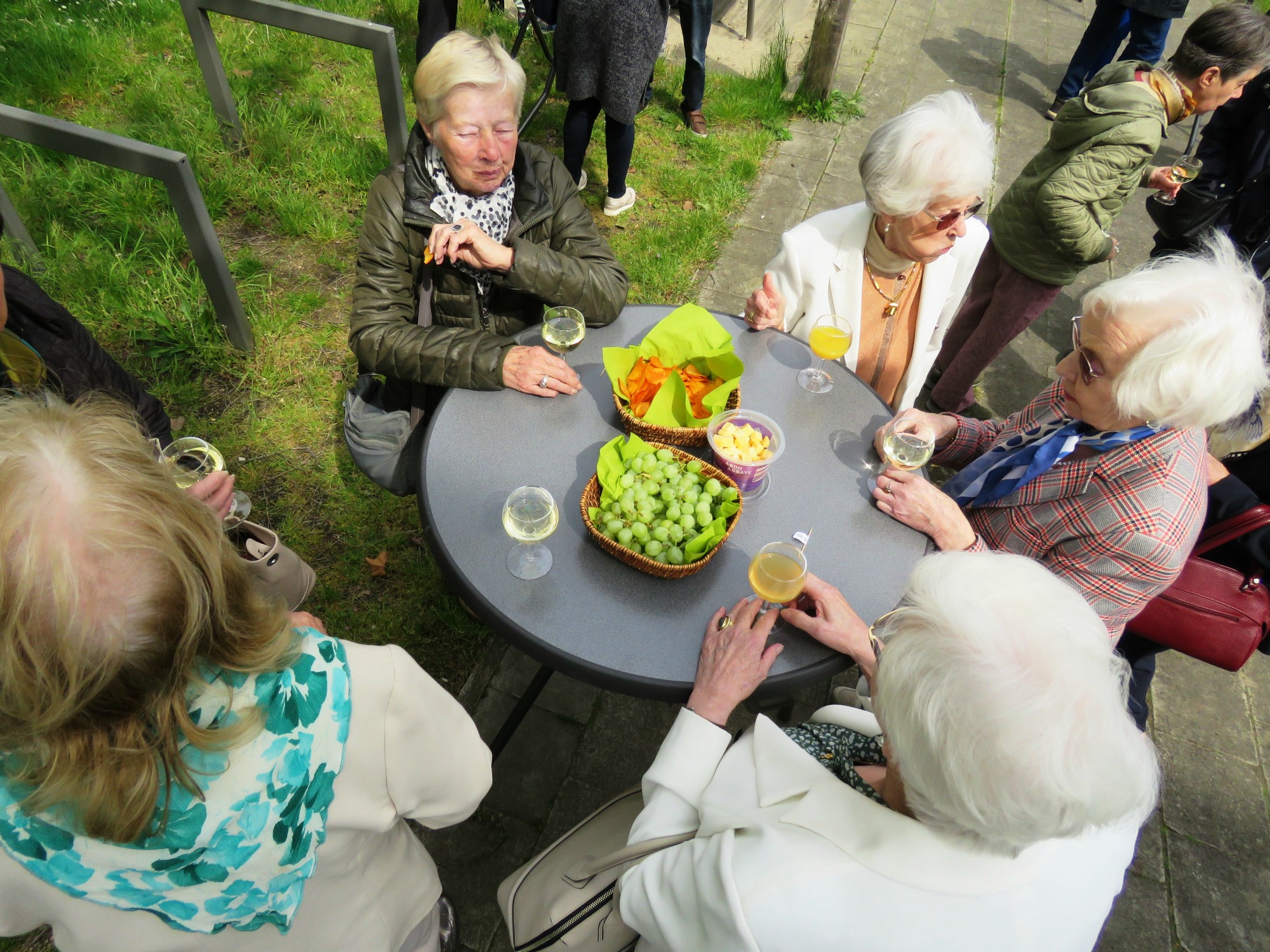 Receptie met deelmoment na de vieiring buiten in de zon aan de Sint-Anna-ten-Drieënkerk, Antwerpen Linkeroever