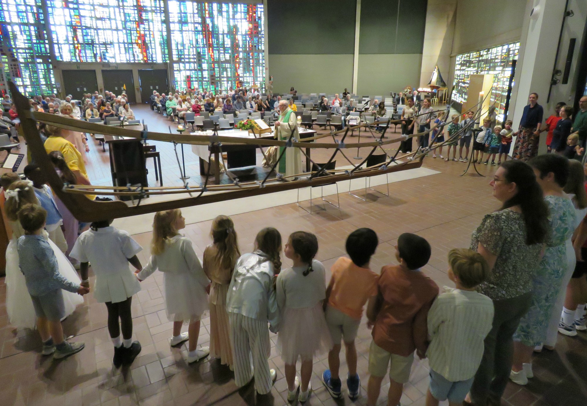 Alle kinderen rondom het altaar en iedereen hand in hand voor het Onze Vader